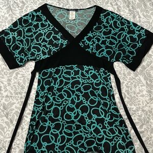 Small form-fitting and business-casual blouse that ties in the back.